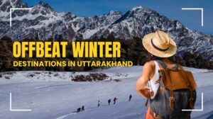 Traveler enjoying a snowy trail surrounded by Himalayan peaks in an offbeat winter destination in Uttarakhand.