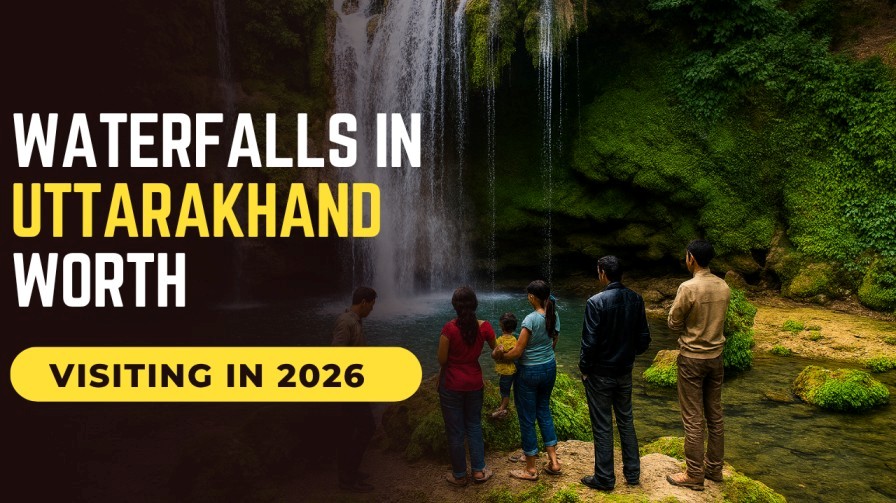 Tourists enjoying a scenic waterfall surrounded by lush greenery in Uttarakhand, India.