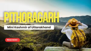Traveler enjoying panoramic view of Pithoragarh valley surrounded by lush green hills.