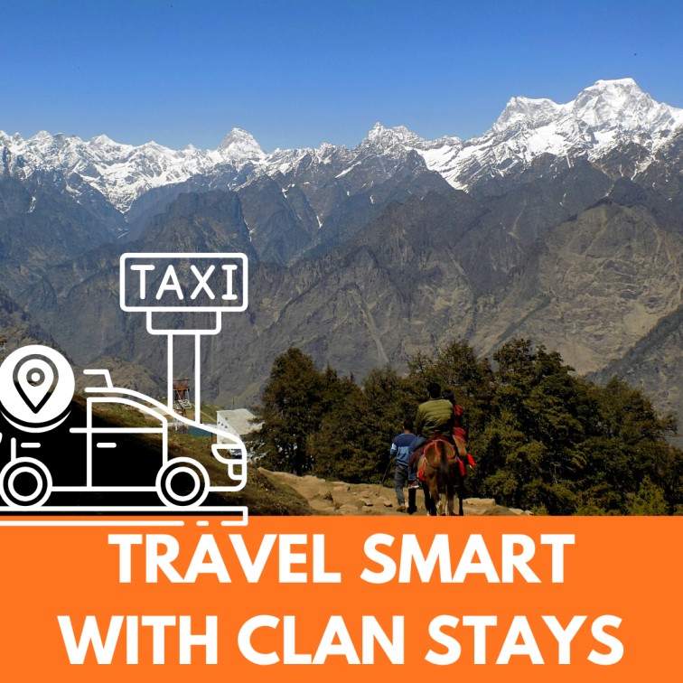 A happy traveler standing on the snowy slopes of Auli with Nanda Devi peak in the background, booked with Clans Stays.